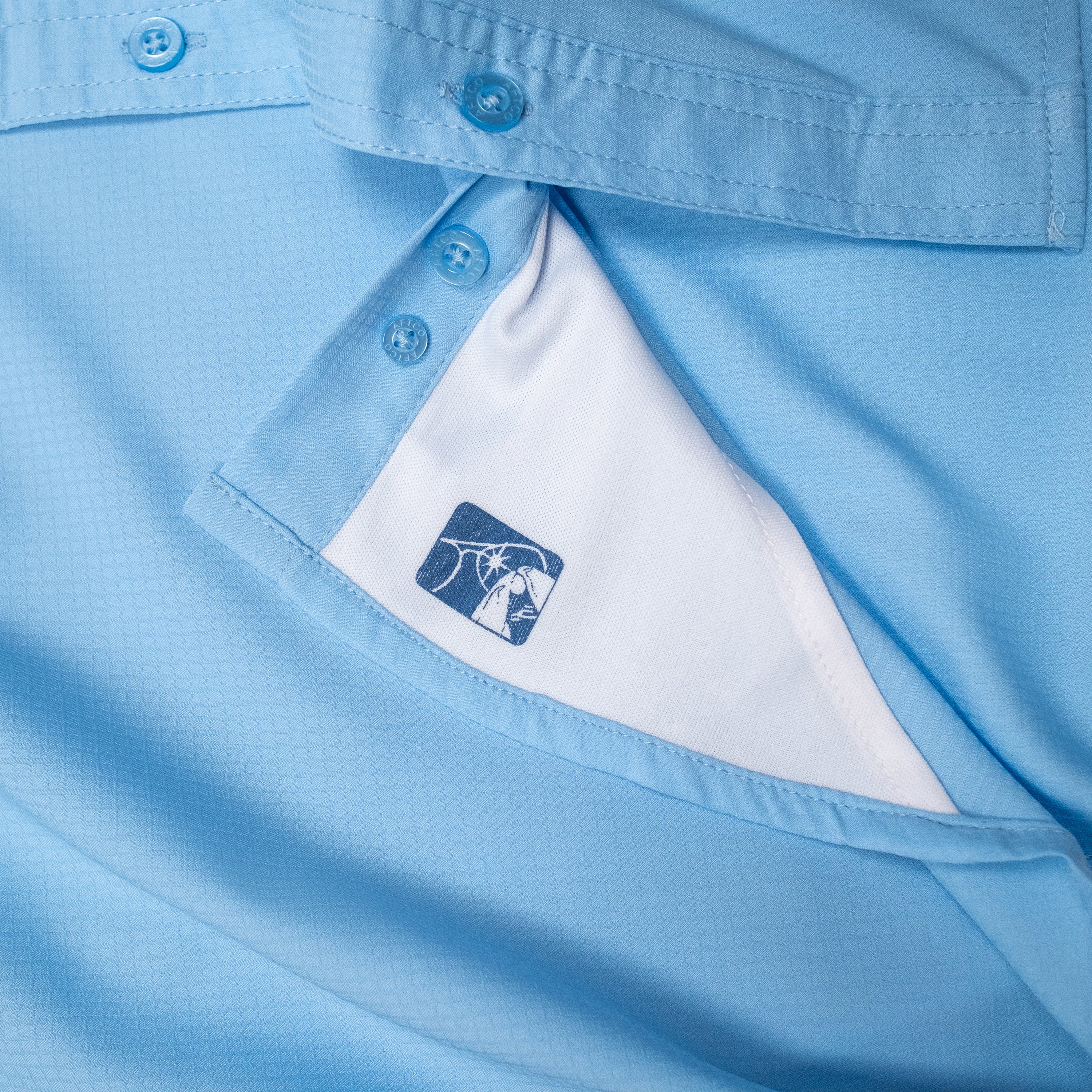 Close-up of a light blue shirt showing the inner label.