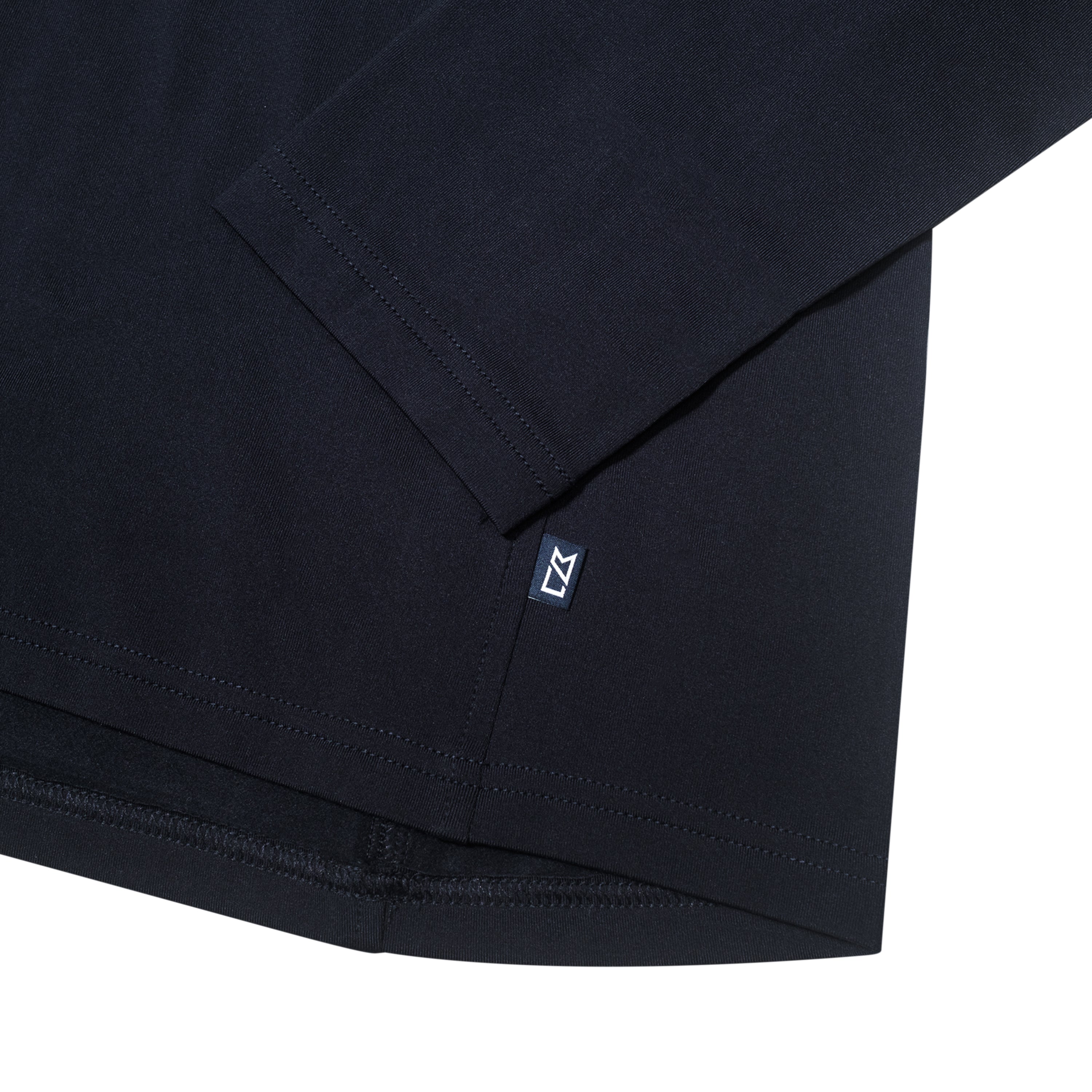 Close-up of the sleeve and hem of a black long-sleeve shirt.