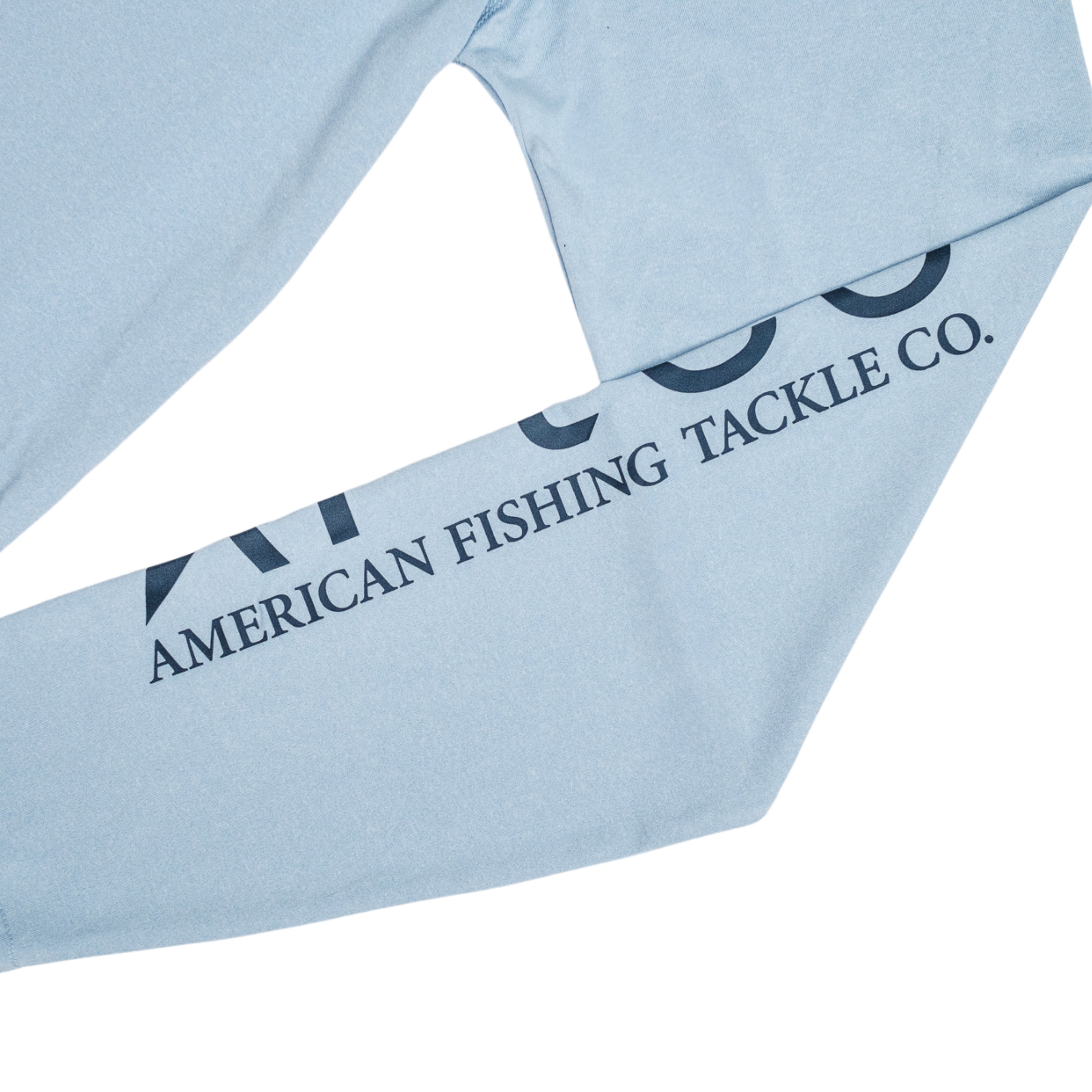 Close-up of a light blue long-sleeve shirt featuring the text 'American Fishing Tackle Co.' on the sleeve.