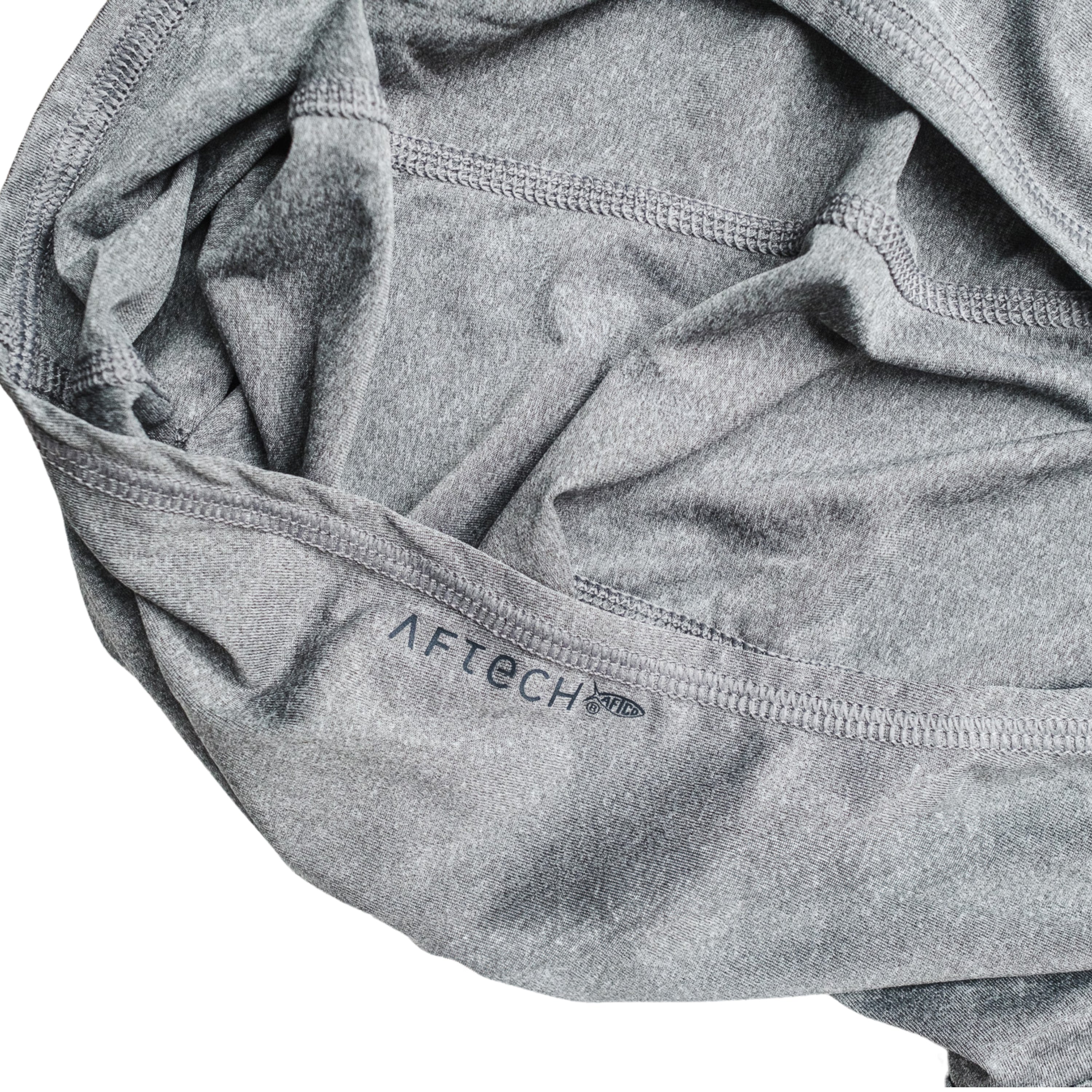 Close-up of a grey fabric hood with the word 'AFTECH' printed on it.