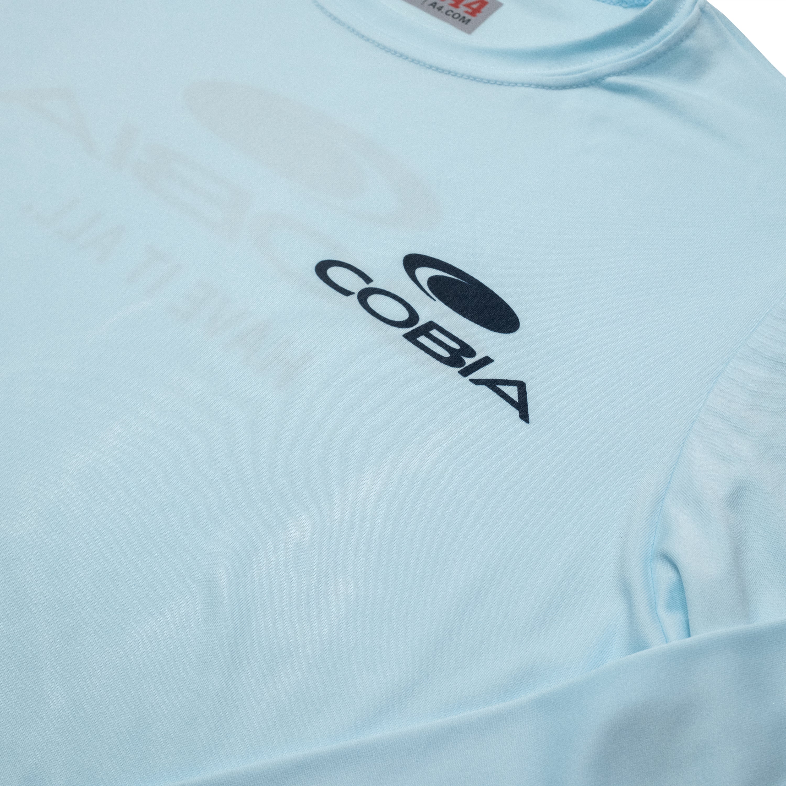 Close up of a light blue shirt with the logo 'COBIA' printed on it.