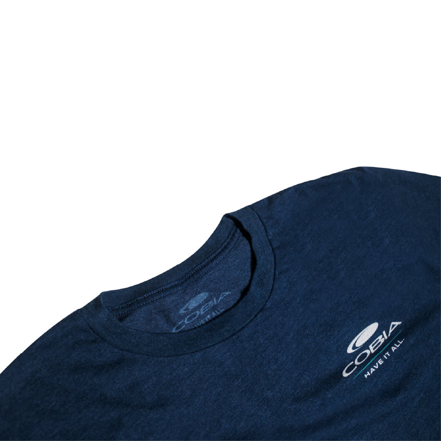 Close-up of a dark blue long sleeve shirt with a white cobia logo on the chest.