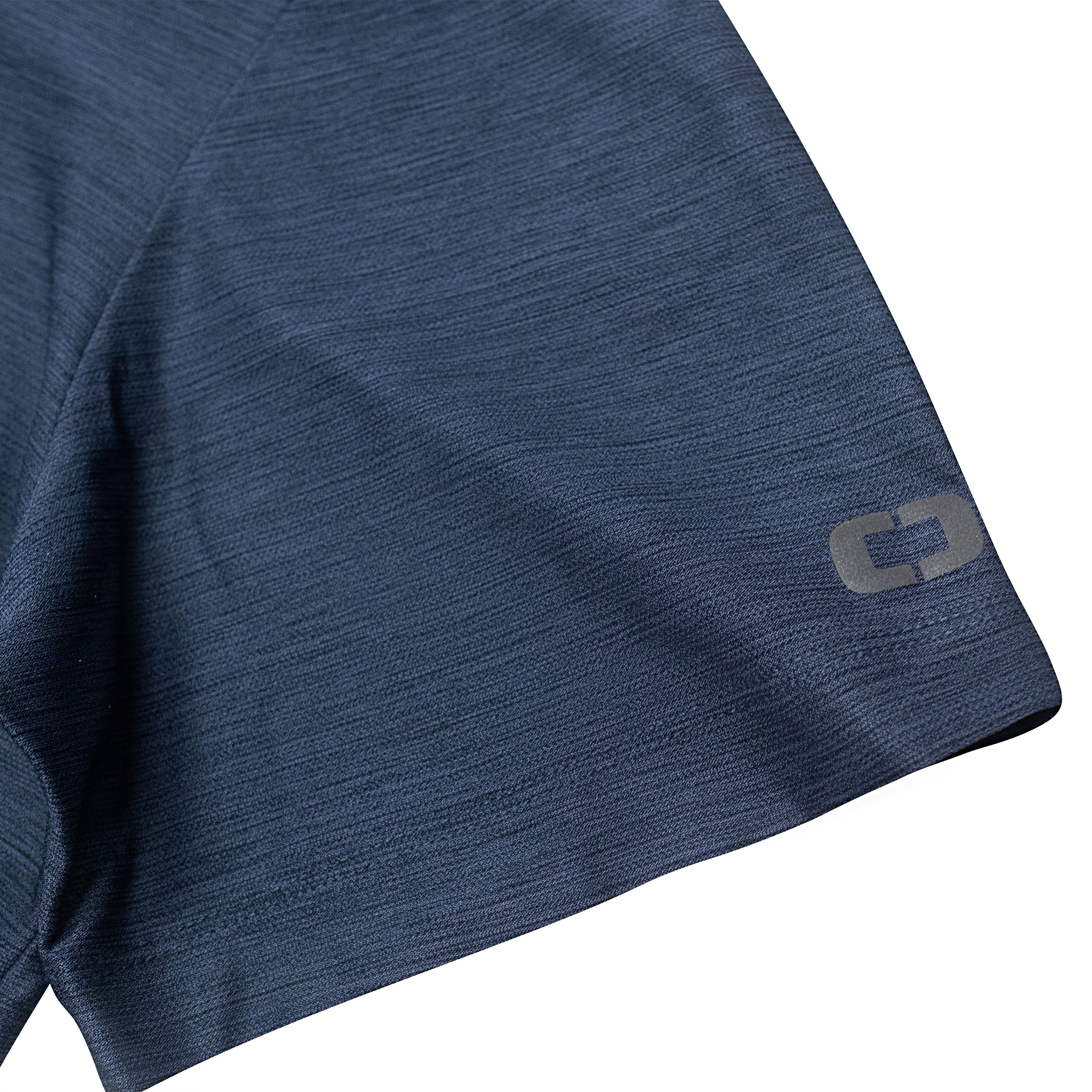 Close-up of a dark blue athletic shirt sleeve with an ogio logo on the cuff.