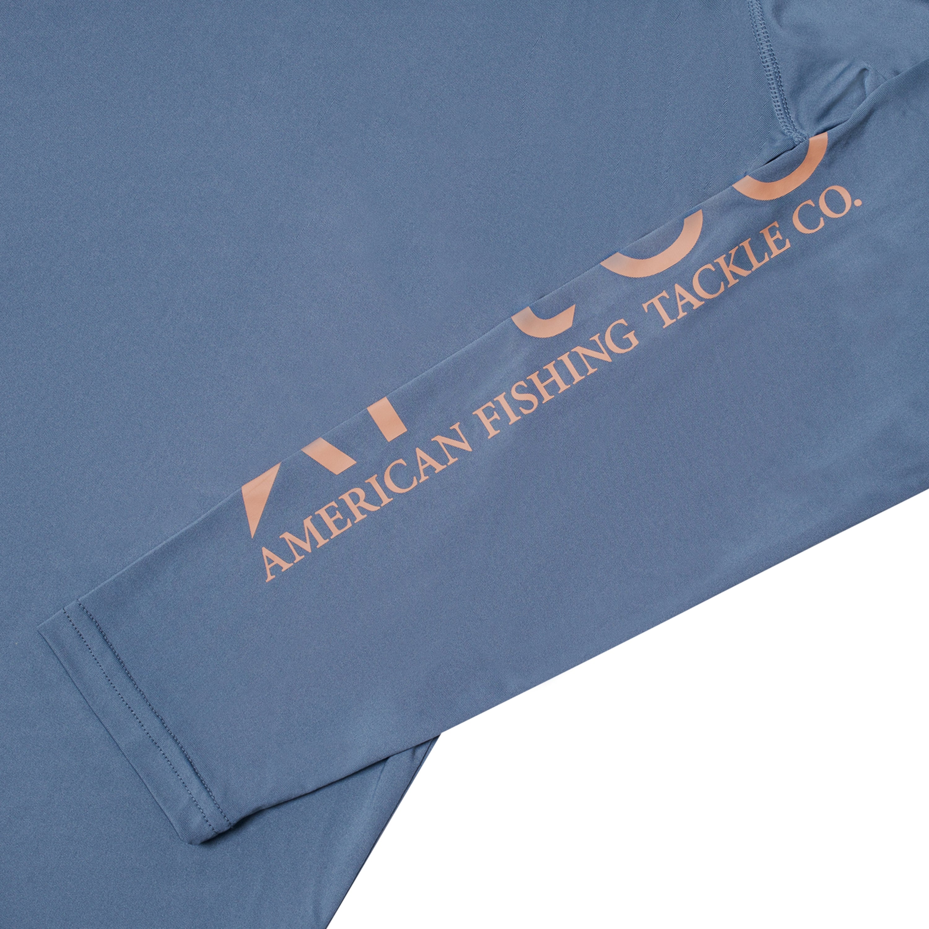 Close-up of a blue long-sleeve shirt featuring the text 'American Fishing Tackle Co.' on the sleeve in pink.