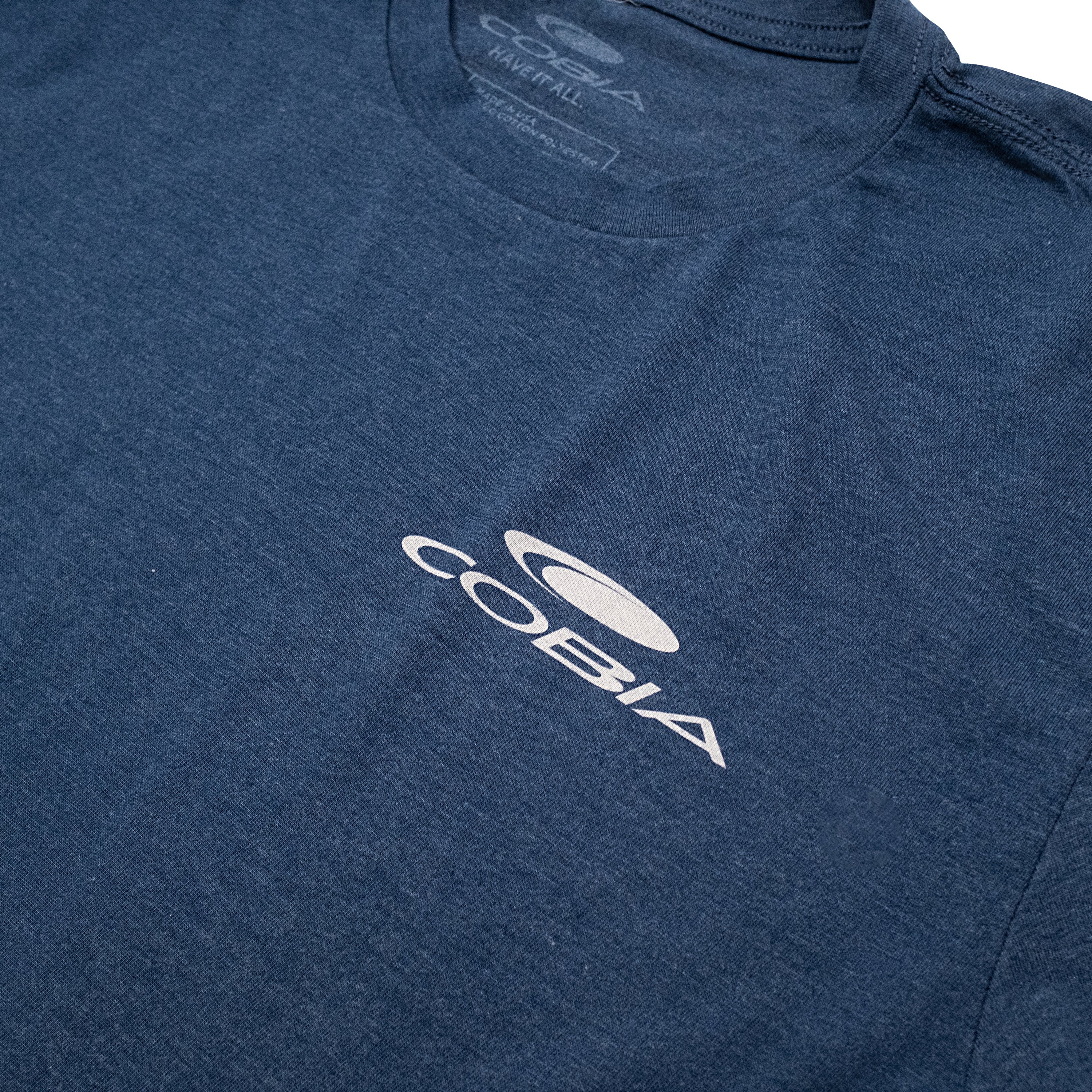 Close-up of a dark blue T-shirt featuring the COBIA logo in white on the chest.