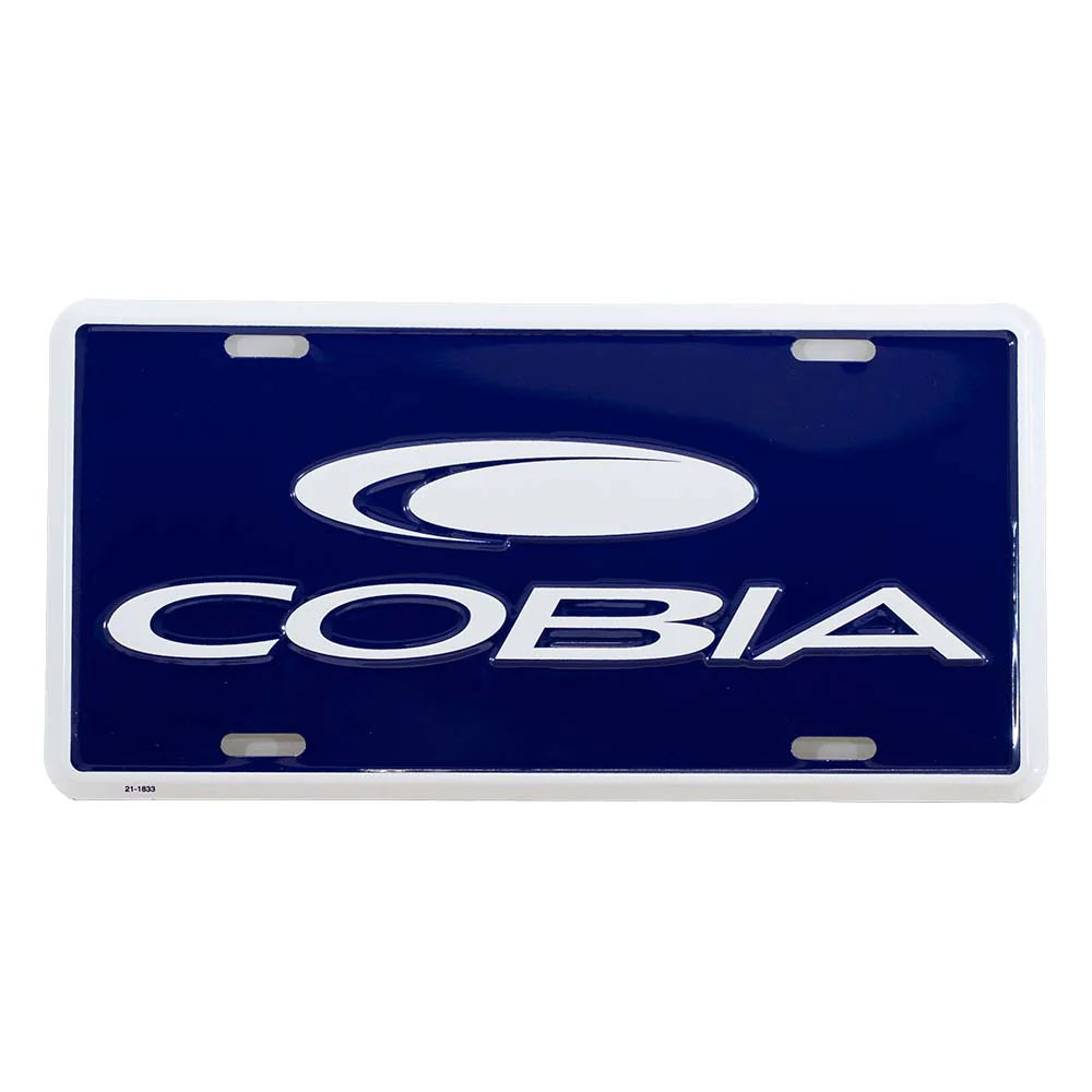 Blue and white license plate with the cobia logo embossed on it. 