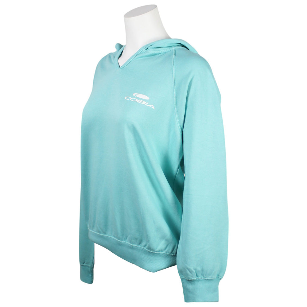Side of a light turquoise hooded sweatshirt with a white Cobia logo printed on the left chest.