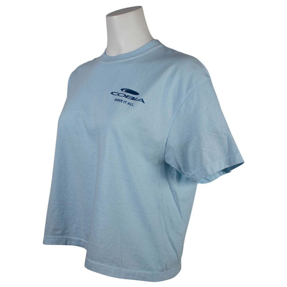Side of a light blue t-shirt with a dark blue cobia logo on the left chest.