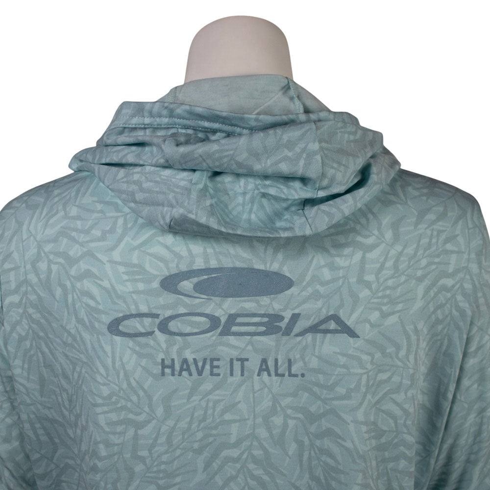 Close up of the back of a light blue hoodie with a pattern and 'Cobia' logo.