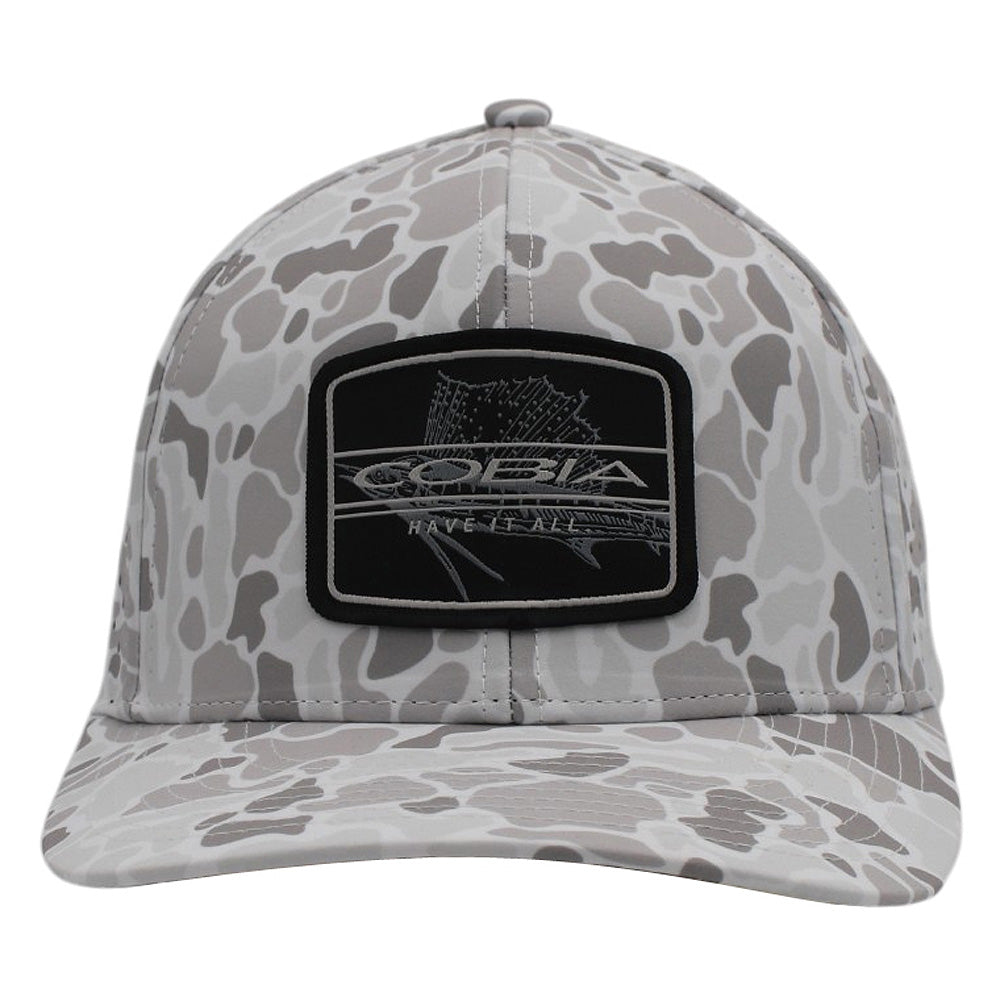 Front of a white and grey camo cap with a black patch on the front containing the cobia logo and a fish design.