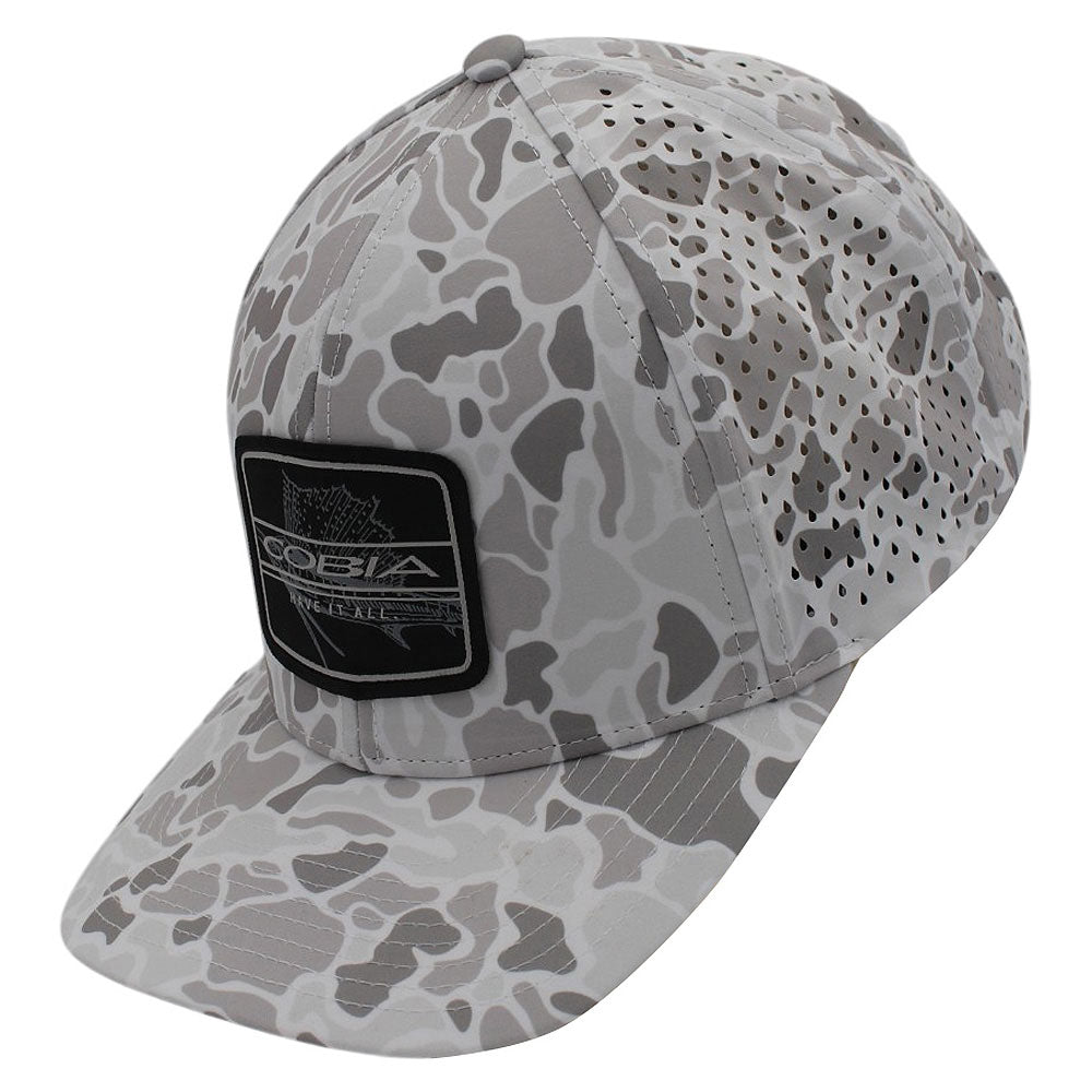 White and grey camo cap with a brand logo patch on the front and ventilation holes on the back panels.