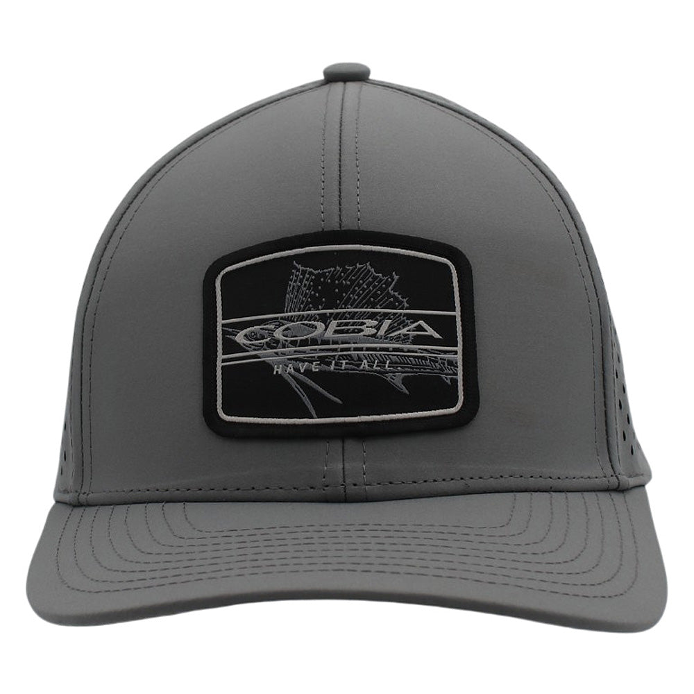 Front of a grey cap with a black patch on the front containing the cobia logo and a fish design.