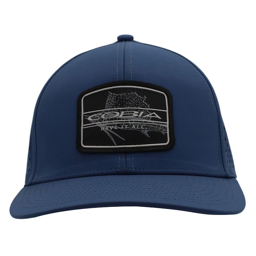 Front of a blue cap with a black patch on the front containing the cobia logo and a fish design.