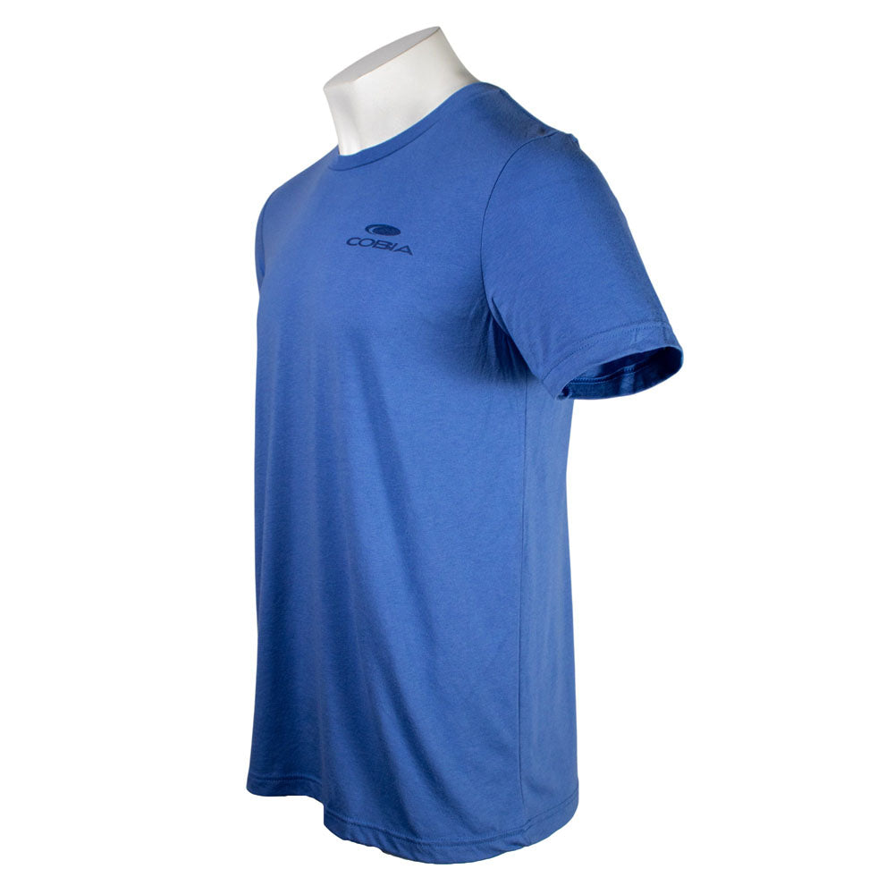 Side of a blue tee with a dark blue cobia logo on the chest. 
