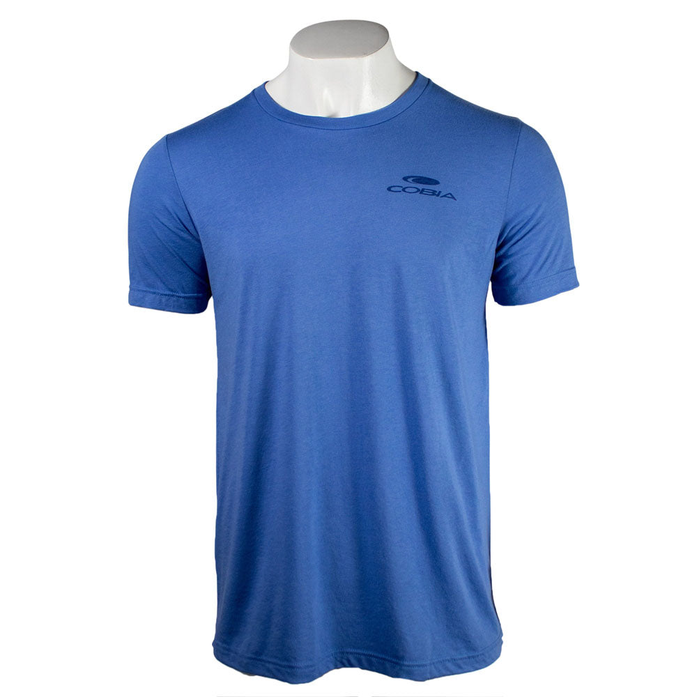 Front of a blue tee with a dark blue cobia logo on the left chest. 