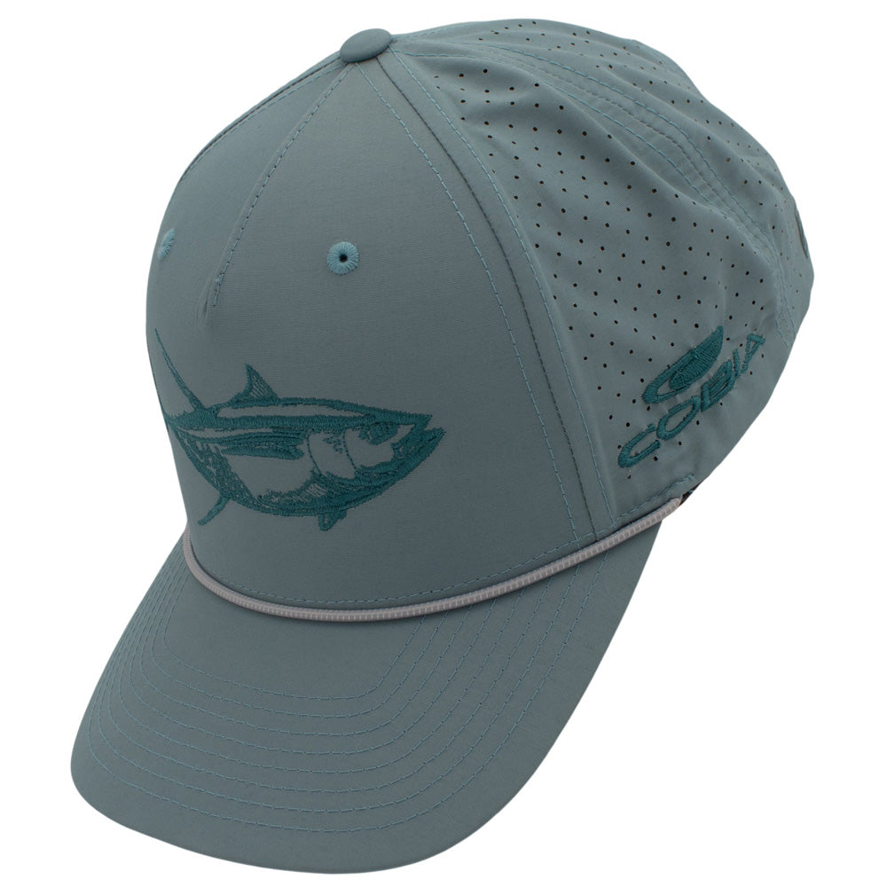Side of a light blue cap with a teal fish design on the front and the cobia logo on the side.